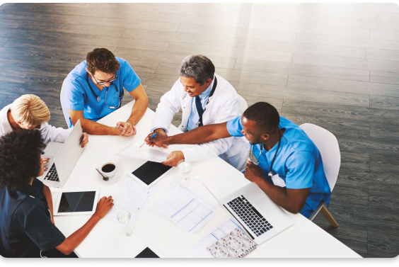 doctors at desk holding meeting2 doctors at desk holding meeting 2